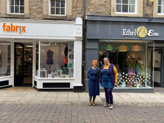 Owners of Fabrix and Ethel & Em standing together outside their shops on New Street, Lancaster.
